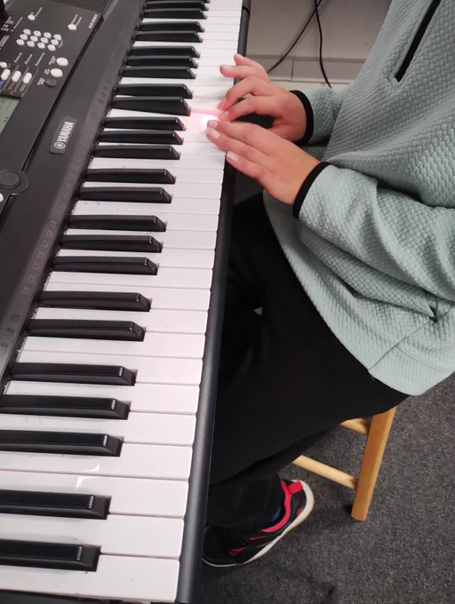 Young person playing keyboard