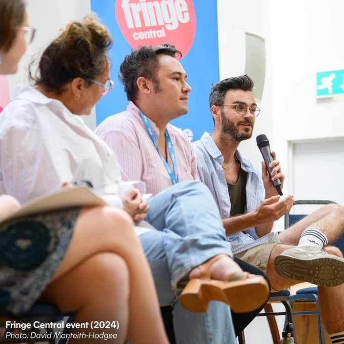 A panelist talks into a microphone at a Fringe Central event. Credit text: Fringe Central event (2024), photo: David Monteith-Hodge.
