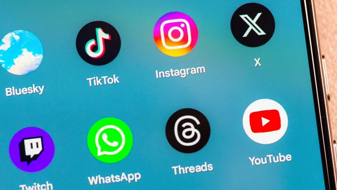 A close-up view of a smartphone screen displaying app icons including TikTok, Instagram, WhatsApp, Twitch, YouTube, and others.