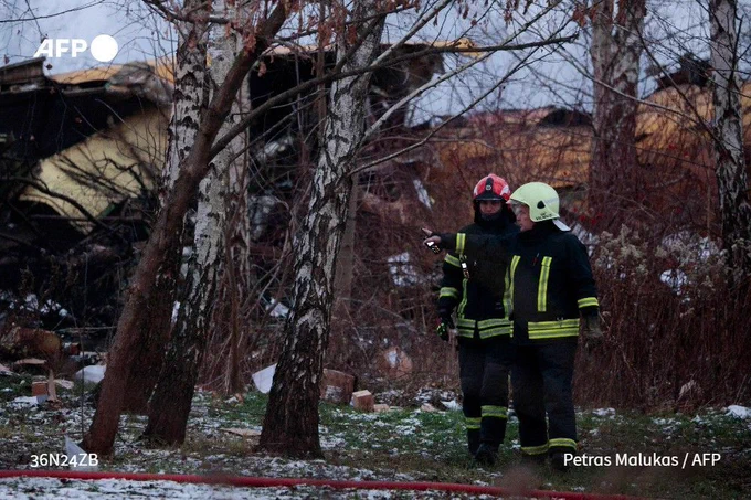 Lithuanian rescuers inspect the wreckage of a cargo plane following its crash near the Vilnius International Airport on November 25, 2024. 