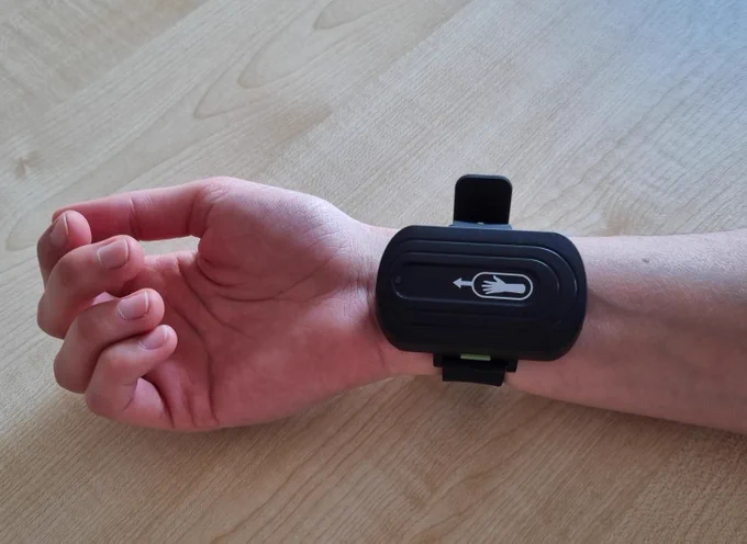 Photo of hand wearing wrist device