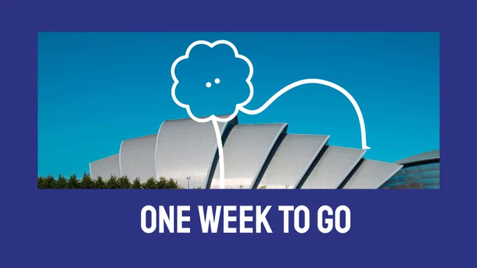 Image of Immersive Arts brand character on a sunny day Glasgow. The character is outlined in white and blog shaped with long bendy legs. The image is displayed on a blue background with text underneath reading, 'One Week to Go.'