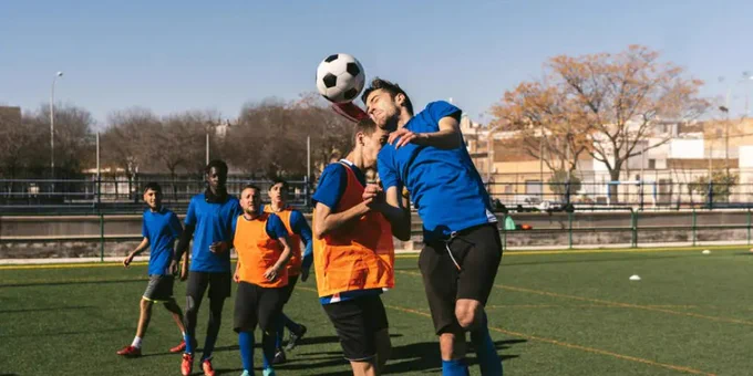 stock image of men playing football
