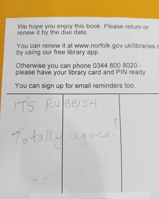 ID: the inside of a book. The library label has, handwritten, the words ‘it’s rubbish’ and ‘totally agree!’ on it.