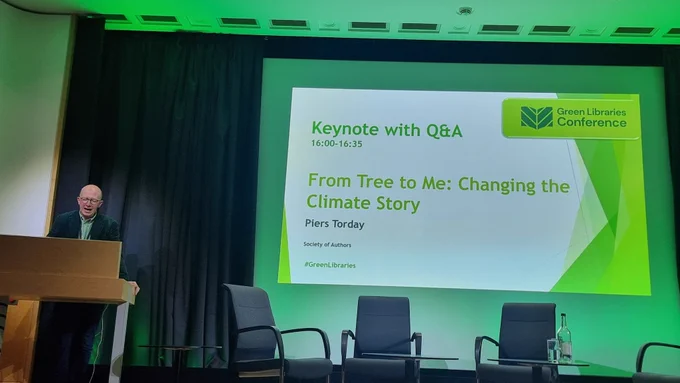 Piers on stage, the slide reading "from trees to me: changing the climate story"