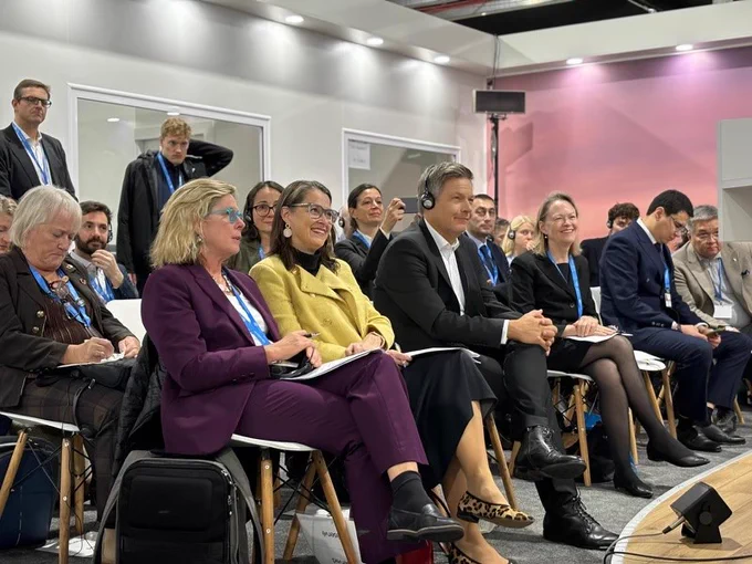 Ambassador of Climate Change sits with delegates at the Canada Pavilion.