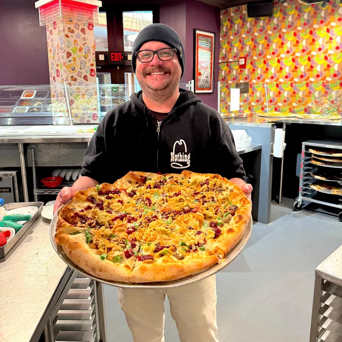 David holding the Thanksgiving Pizza