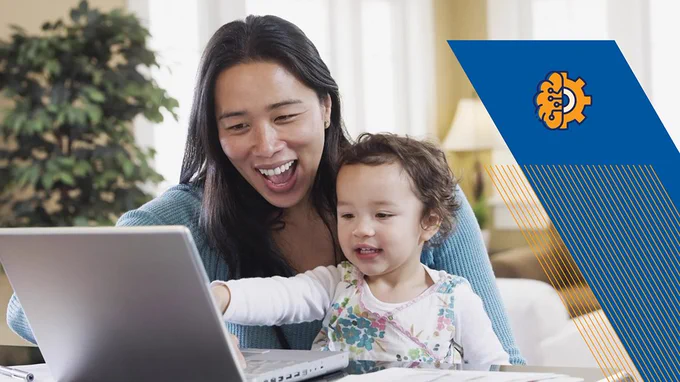 Image Description: A mother with a child sitting on her lap looking at a laptop.