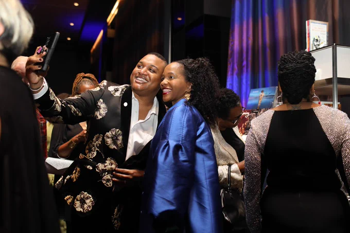 A photo of Ernest Owens and someone else taking a selfie at the 2023 BlackStar Luminary Gala. They are smiling. 

