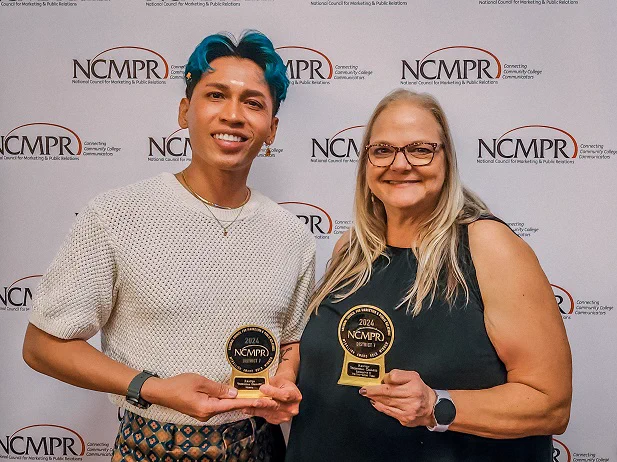 Beasley (left) and Hedland-Hansen (right) holding awards, standing in front of a backdrop with the NCMPR logo. They are smiling and posing for the photo.