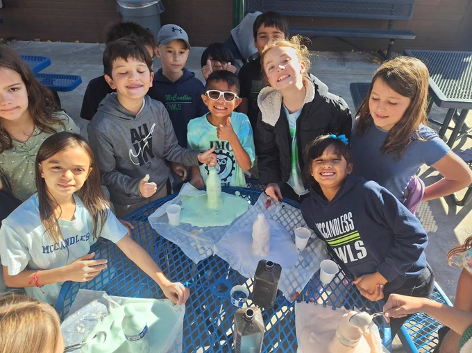Fourth Graders have mixed hydrogen peroxide, yeast, dish soap, food coloring and water to create a substance that is foaming out of water bottles