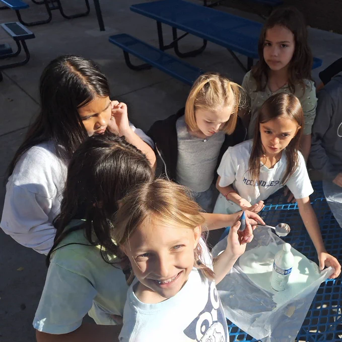 Fourth Graders have mixed hydrogen peroxide, yeast, dish soap, food coloring and water to create a substance that is foaming out of a water bottle