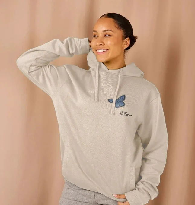 Person wearing a cream RES Large blue butterfly hoodie