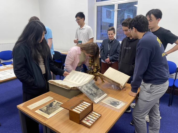 A group of students looking at material from the Ross collection of LSHTM Archives