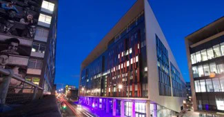 The Technology and Innovation Centre Building lit up in colour purple for International Day of People with Disabilities. 