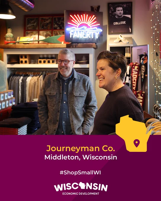 Two people smiling in a boutique clothing store, Journeyman Co. in Middleton, Wisconsin. Prominent signage includes #ShopSmallWI and Wisconsin Economic Development logos.