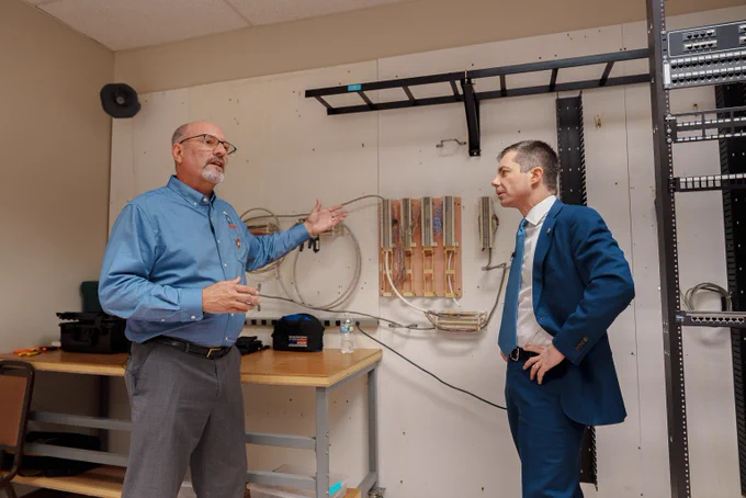 Secretary Pete and an instructor on a tour at an IBEW Training Facility. 
