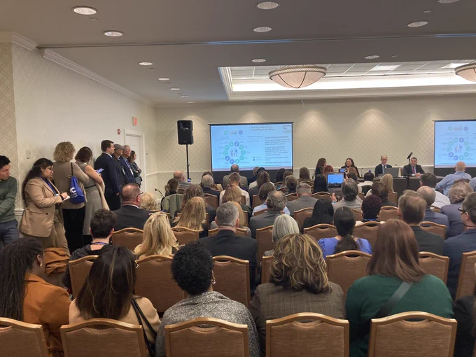 Room full of attendees of panel discussion