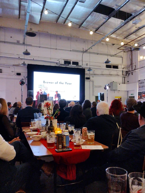 Brewer of the year presentation, person on stage in front of big screen.