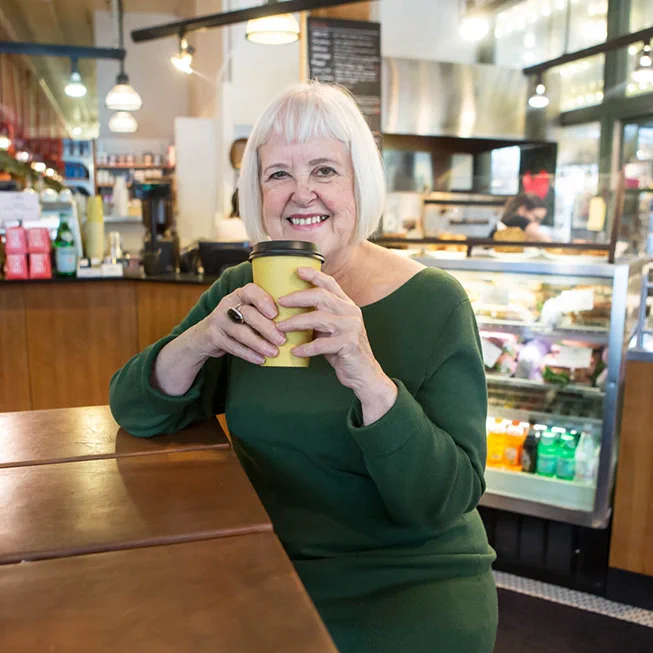 Zoe Freeman enjoys a cup of coffee at a cafe located within Pike Place Market in Seattle, Washington. 