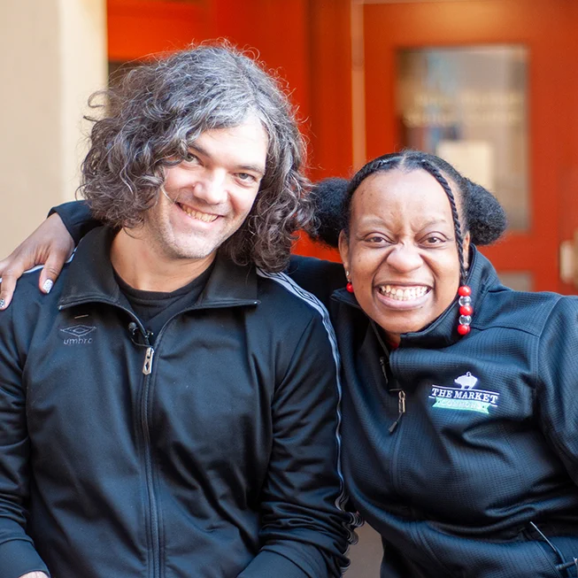 Mason Lowe and Velma Chaney pose together at Pike Place Market in Seattle, Washington. 