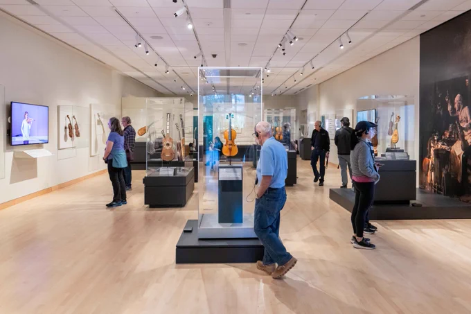 A wide view of MIM’s special exhibition Stradivarius and the Golden Age of Violins and Guitars. The “Tartini” Stradivarius is displayed in a vitrine front and center.