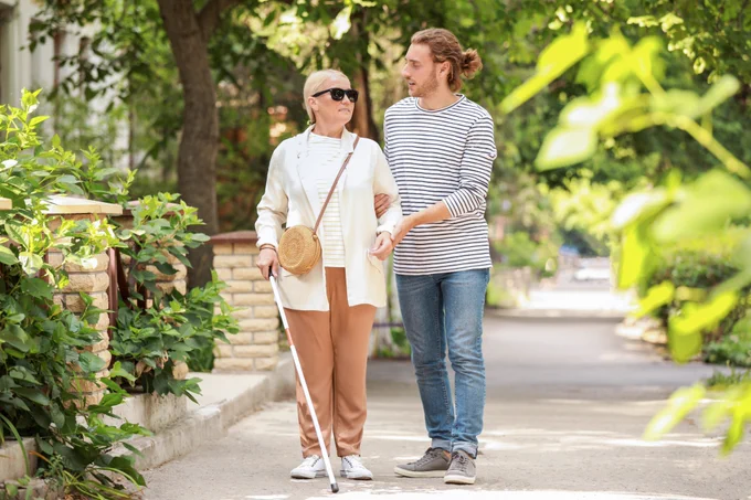 Blind female with helper outdoors