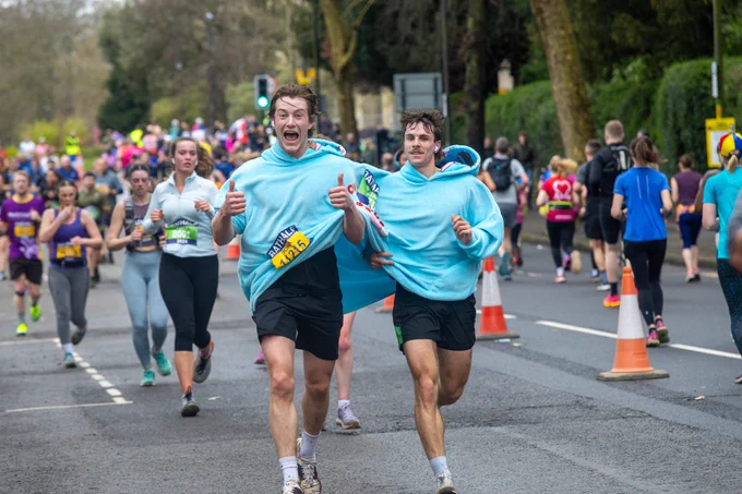 A photo of two male runners wearing in a massive jumper.