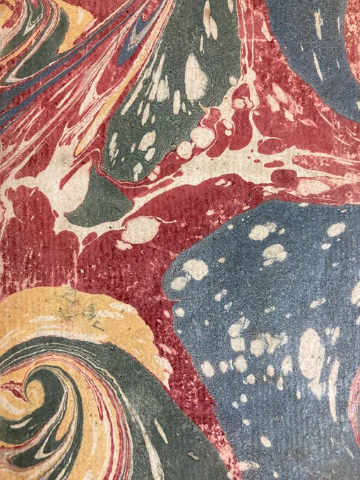 CHS 325 Marbled Endpapers: Marbled endpapers in swirls of blue, red, yellow, and green, with white splodges throughout.