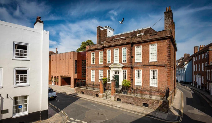 Large red brick building seen across the road