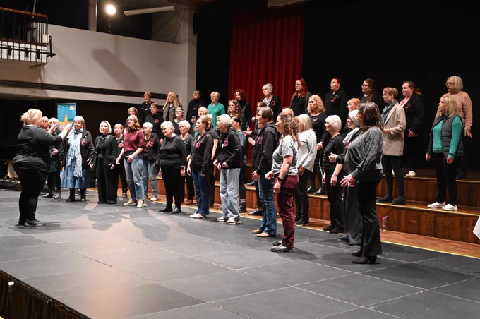 Female choir singing on stage