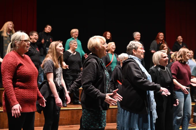 Group of women singing on stage