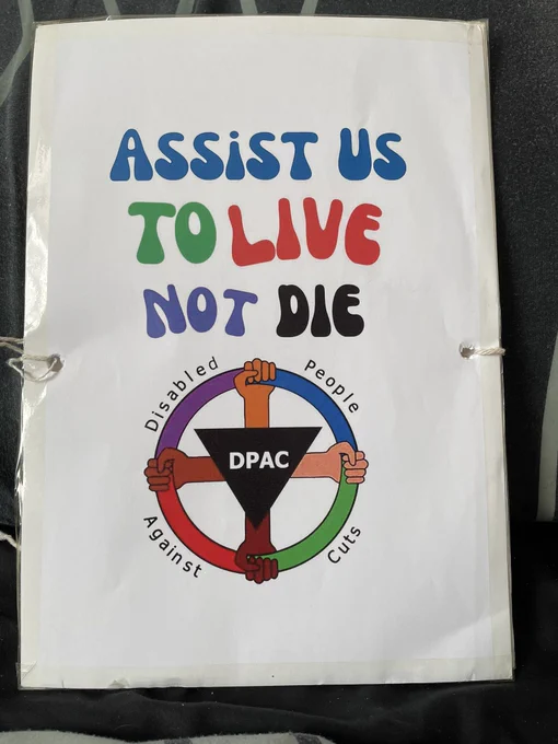 On a white background at the top in blue text Assist Us  in Green Text To in Red Text live in purple text Not in Black text Die 

Underneath is the DPAC logo