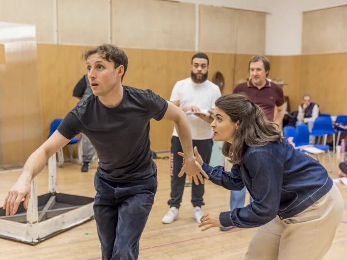 Ned Costello is Hansel and Yasemin Ozdemir is Gretel in Hansel and Gretel (2024/5). 

Two actors wearing street clothes rehearse for a performance in a rehearsal studio. 