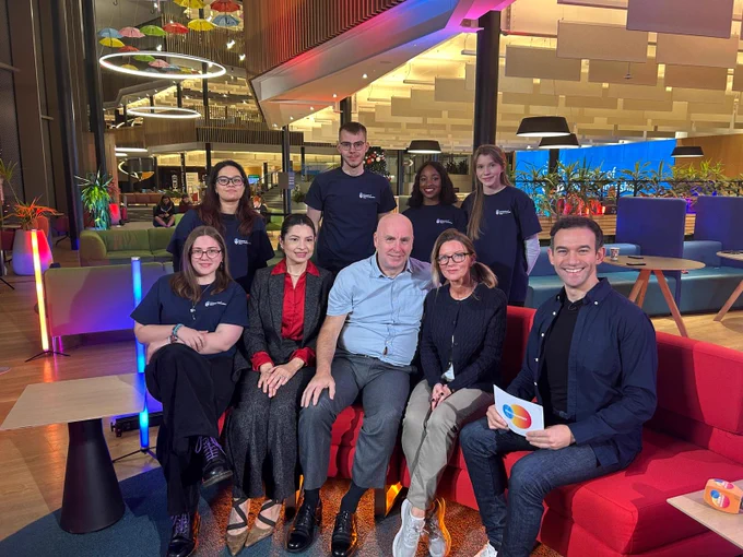 Experts and students sit on the replica red BBC Breakfast red settee with TV presenter Ben Boulus in our Student Centre. 