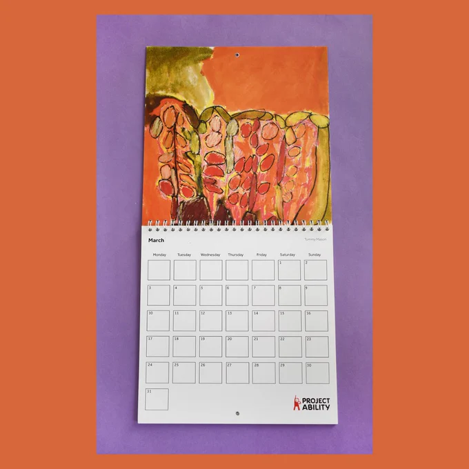 A burnt orange background for a photo of a calendar. The calendar rests against a purple backdrop and is open in the March spread. The top half is a painting of orange and yellow plants and the bottom half has the month spread. The artwork is by Tommy Mason.