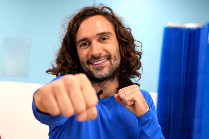 Joe Wicks smiling, doing a work out. 