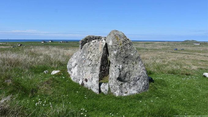 A photo of a large stone prehistoric monument in a sunny landscape