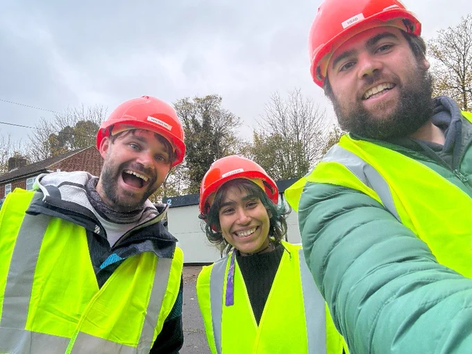 Josh, Sara and Gotch in hard hats and hi-vis on their scaffolding course