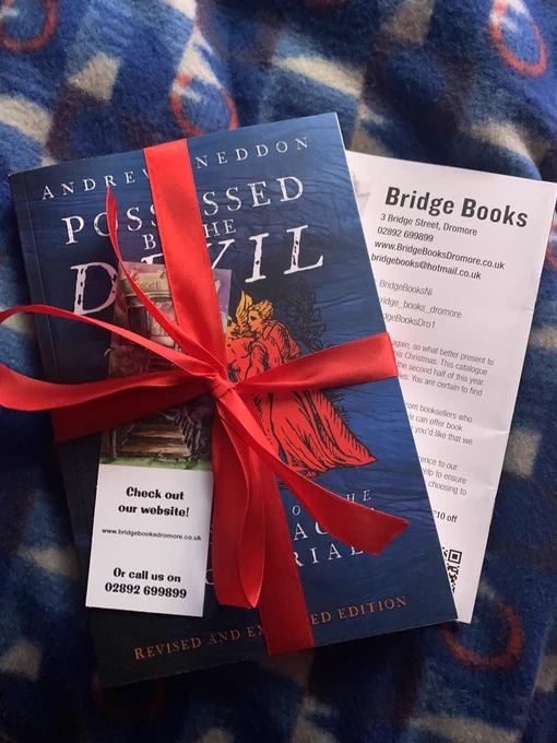 The book Possessed By The Devil by Dr Andrew Sneddon wrapped in red ribbon & accompanied with a bookmark & literature from Bridge Books