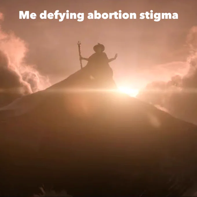 [Image description: Silhouette of Elphaba from Wicked (2024) with floating in the sky against a luminous sunset, with the text "Me defying abortion stigma" overlaid at the top.]