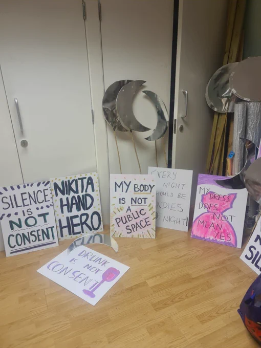 A collection of hand painted placards and silver moon shapes including 'Nikita Hand Hero' 