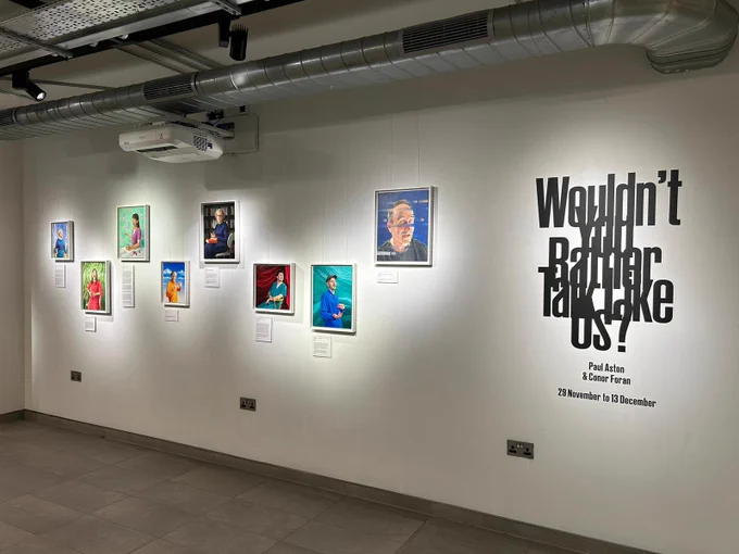 Photograph of a collection of 8 individual portraits painted by Paul Aston exploring the moment of stammering