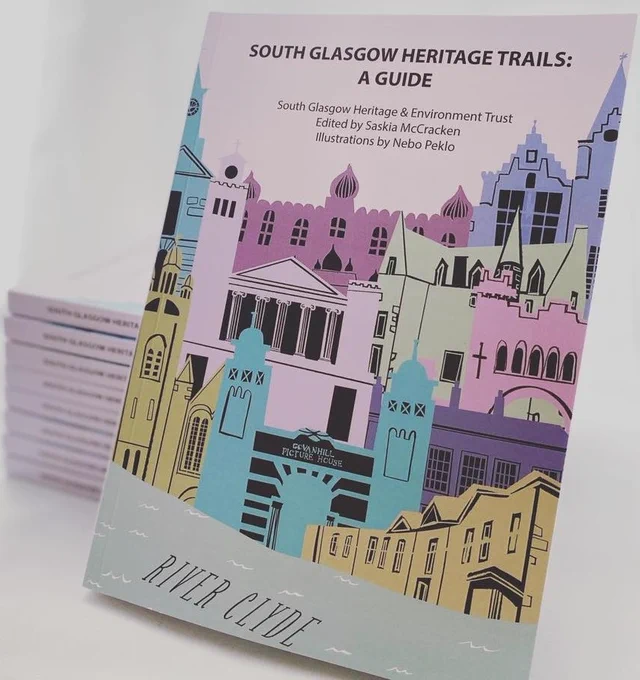 Photo of the cover of our South Glasgow Heritage Trails guidebook with cover artwork by Nebo Peklo comprised of a stylised range of Southside landmark buildings, and a larger stack the guidebooks behind it.