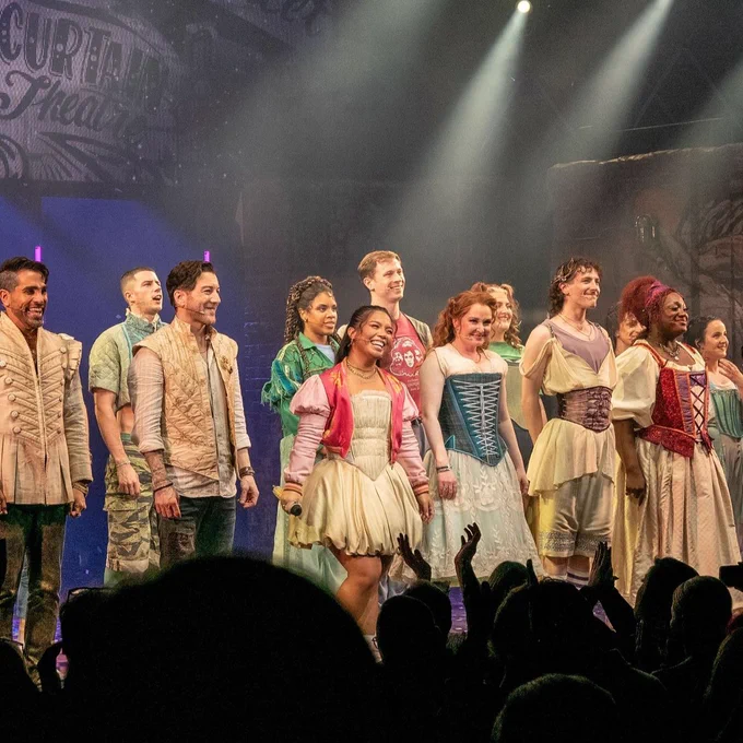 Matt Cardle and the cast of & Juliet onstage in the bows, smiling and looking into the audience.