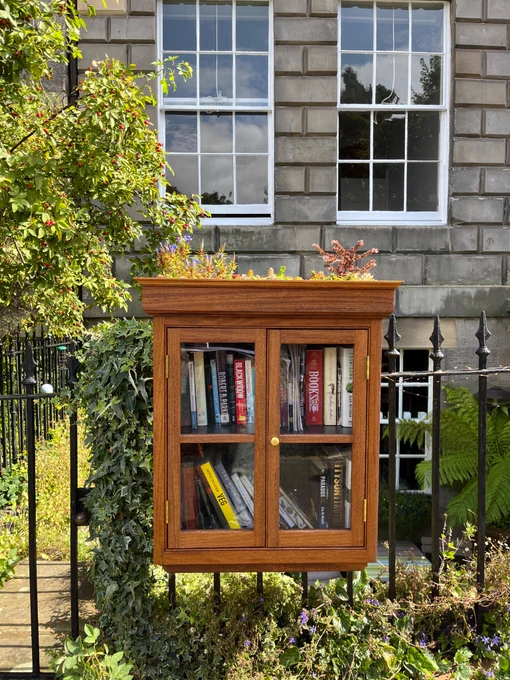 Small free library outside of a georgian building