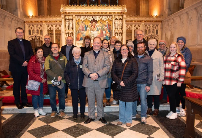 Nineteen people standing in front of the altar in the Church of Ireland cathedral Armagh.