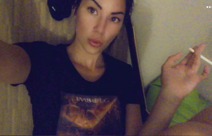 Model Jovana Wearing a black shirt with Imbolg art work for the album the Sorrows