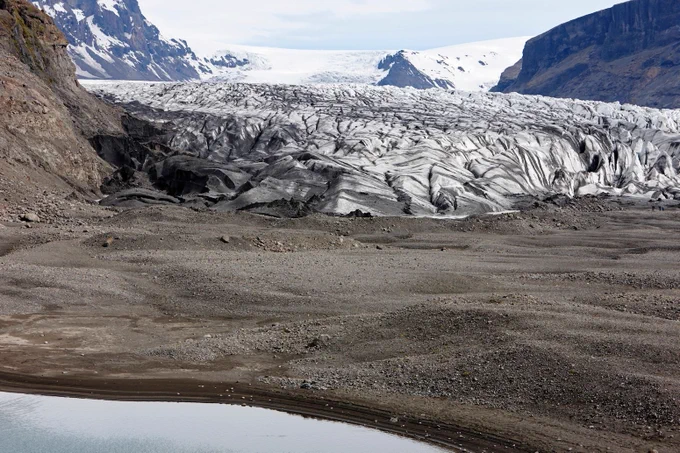 Ash covered Skaftafell glacier in Iceland. Credit: Radharc Images / Alamy Stock Photo

