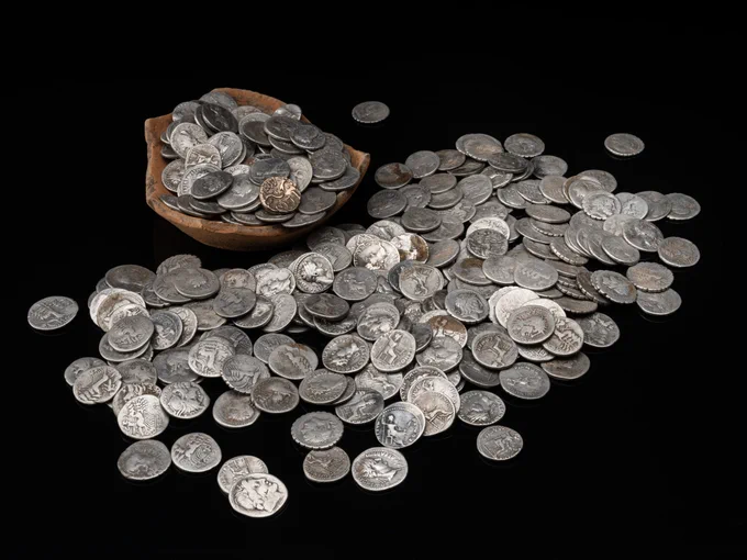 A photo showing a selection of Roman silver denarii against a black background.